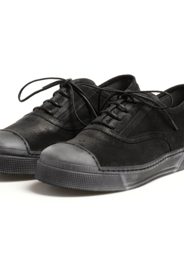Shoe with a rubber sole and laces